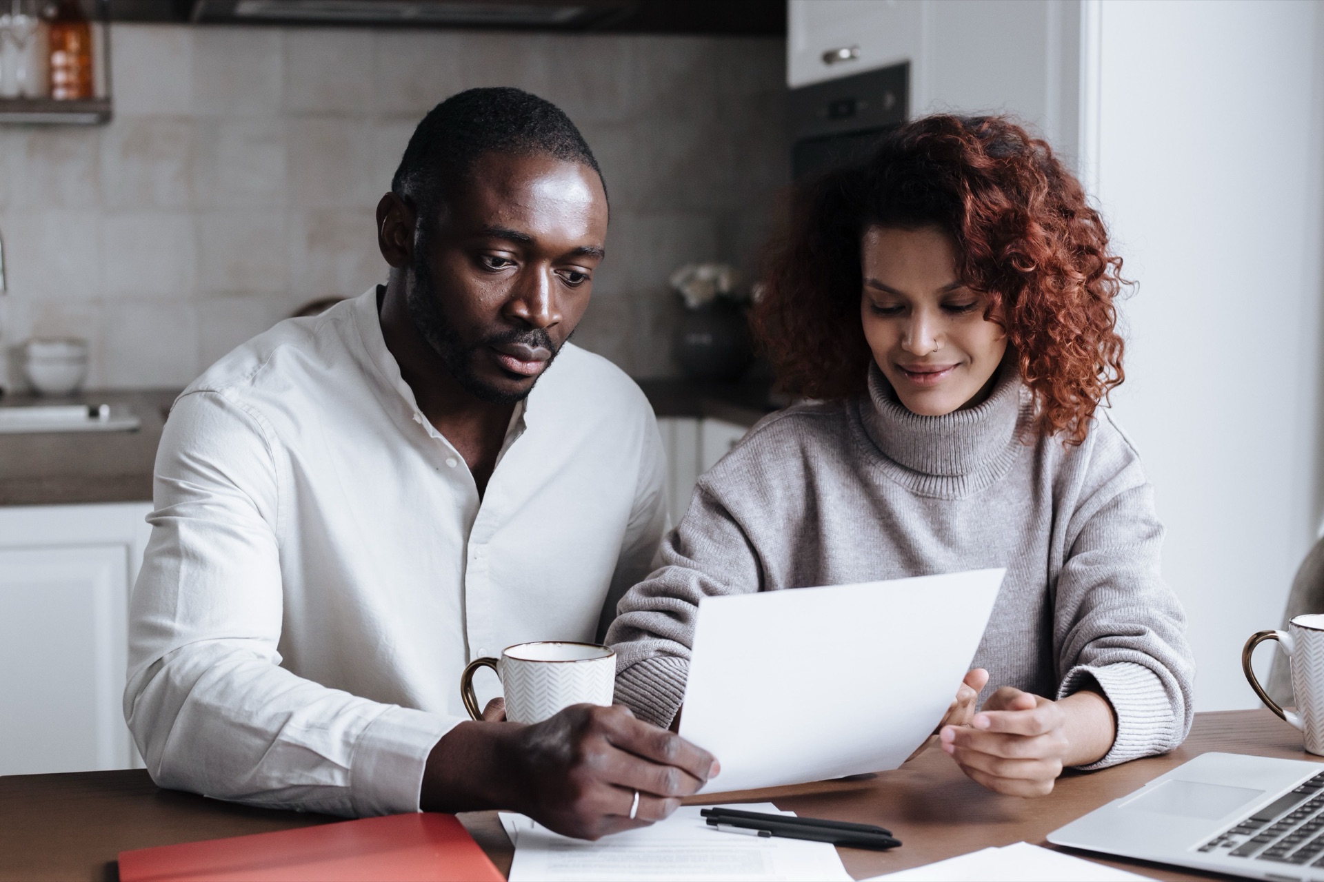 A couple reviewing their home budget together at the kitchen table
