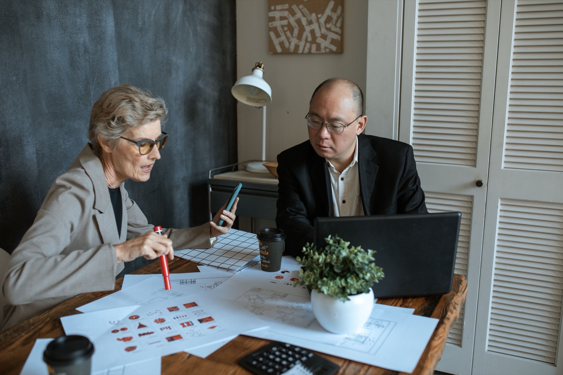 Small business owner reviewing financial documents at desk